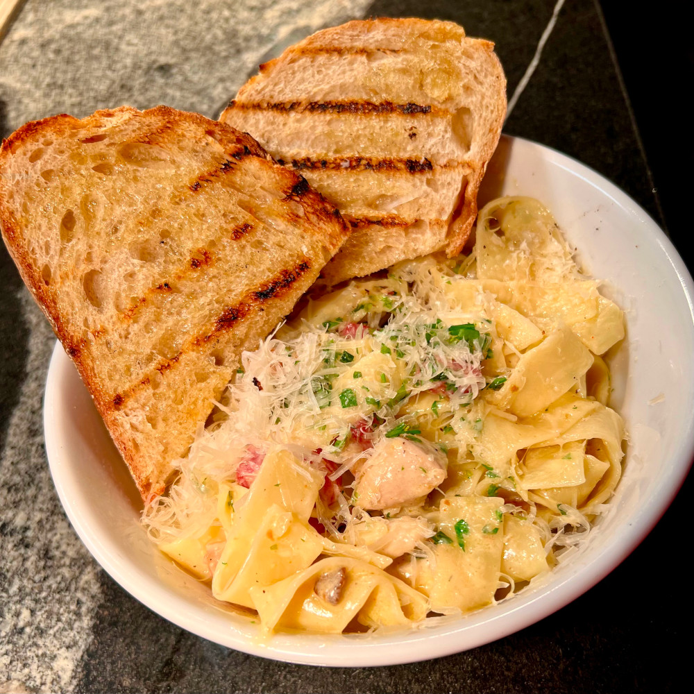 Dinner portion pancetta, pappardelle, parsley, cracked pepper, parmesan, garlic toast.