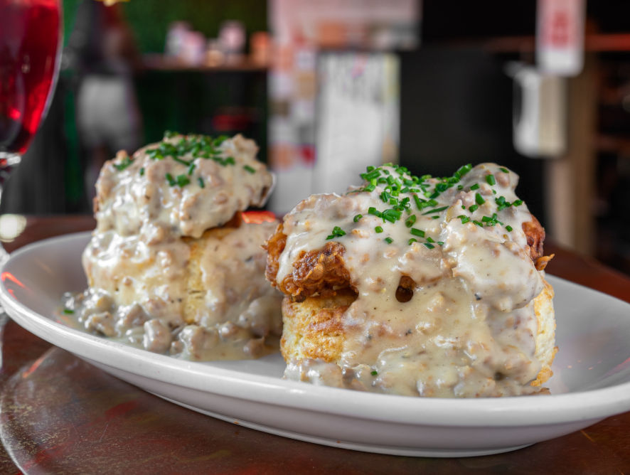 Biscuits and sausage gravy topped with fried chicken